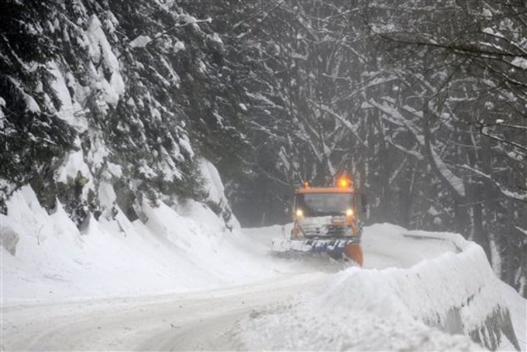 A snow plow clears a road near Harrachov in the Krkonose Mountains (Giant Mountains), 80 miles northeast of Prague, Wednesday, Feb. 15. 